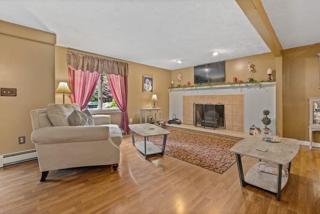 33 R F Higgins Drive Norwell, MA 02061 - Photo 16 of 34 a living room with furniture and a fireplace