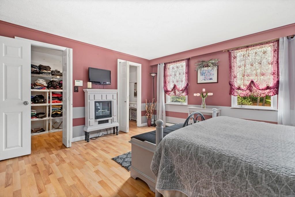 33 R F Higgins Drive Norwell, MA 02061 - Photo 18 of 34 a bedroom with a bed and a flat screen tv