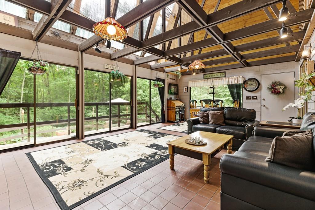 33 R F Higgins Drive Norwell, MA 02061 - Photo 2 of 34 a living room with furniture and a floor to ceiling windows