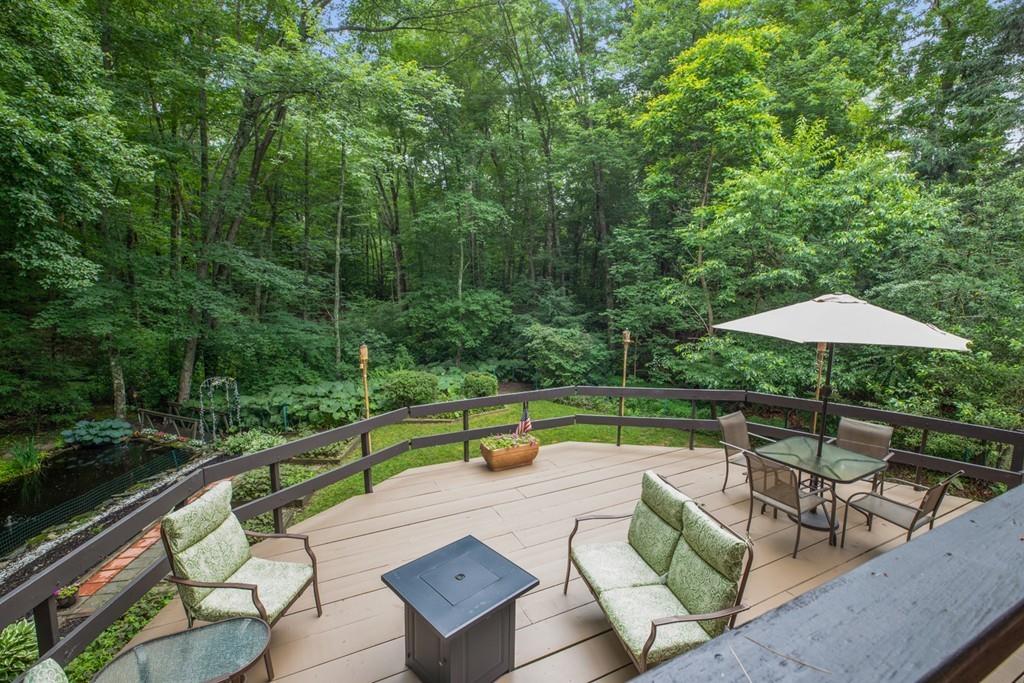 33 R F Higgins Drive Norwell, MA 02061 - Photo 28 of 34 a view of a patio with chairs under an umbrella