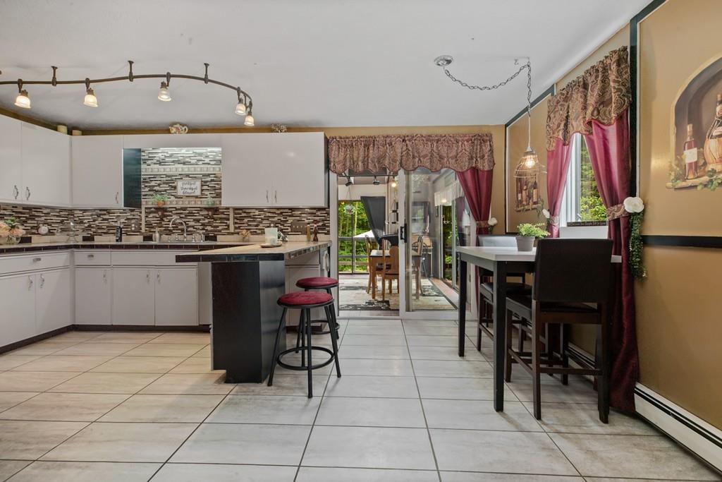 33 R F Higgins Drive Norwell, MA 02061 - Photo 5 of 34 a view of kitchen with stainless steel appliances granite countertop a table and chairs in it