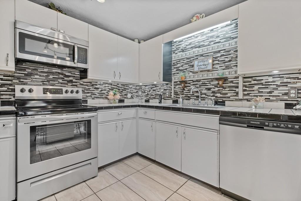 33 R F Higgins Drive Norwell, MA 02061 - Photo 6 of 34 a kitchen with granite countertop white cabinets stainless steel appliances and a sink