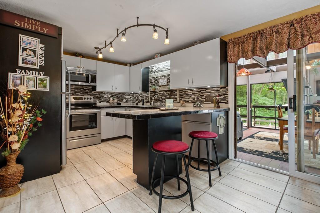 33 R F Higgins Drive Norwell, MA 02061 - Photo 7 of 34 a kitchen with stainless steel appliances granite countertop a sink and cabinets