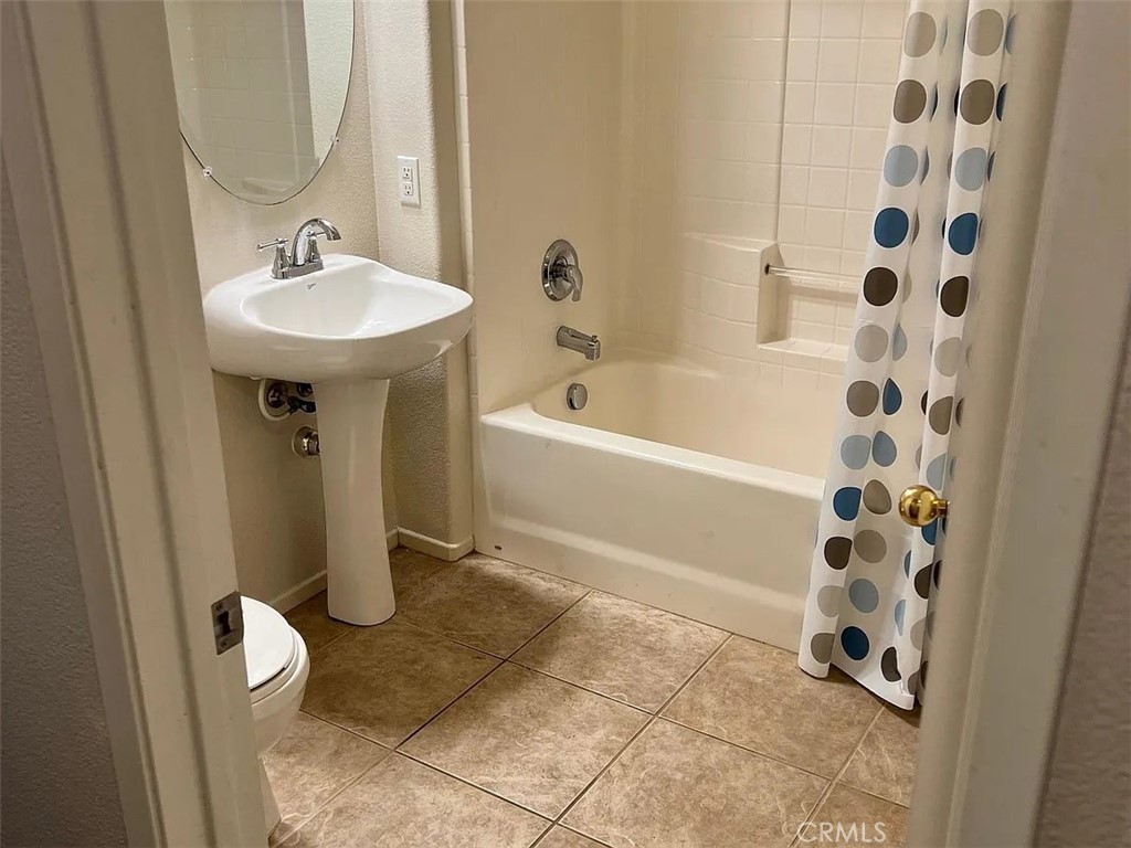 26456 Arboretum Way, Unit 1104 Murrieta, CA 92563 - Photo 5 of 12 a bathroom with a sink a toilet and shower