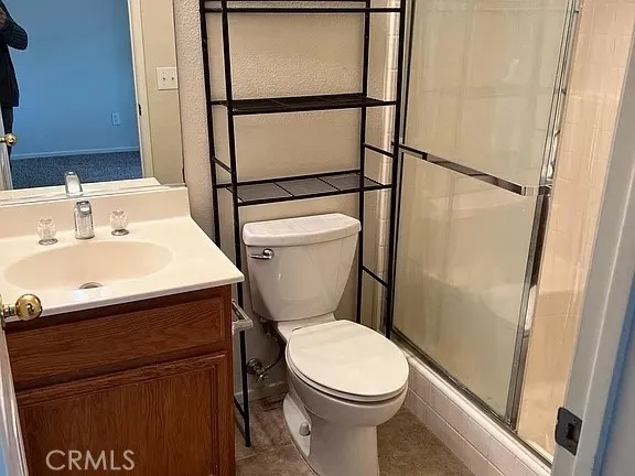 a white toilet sitting next to a bathroom sink