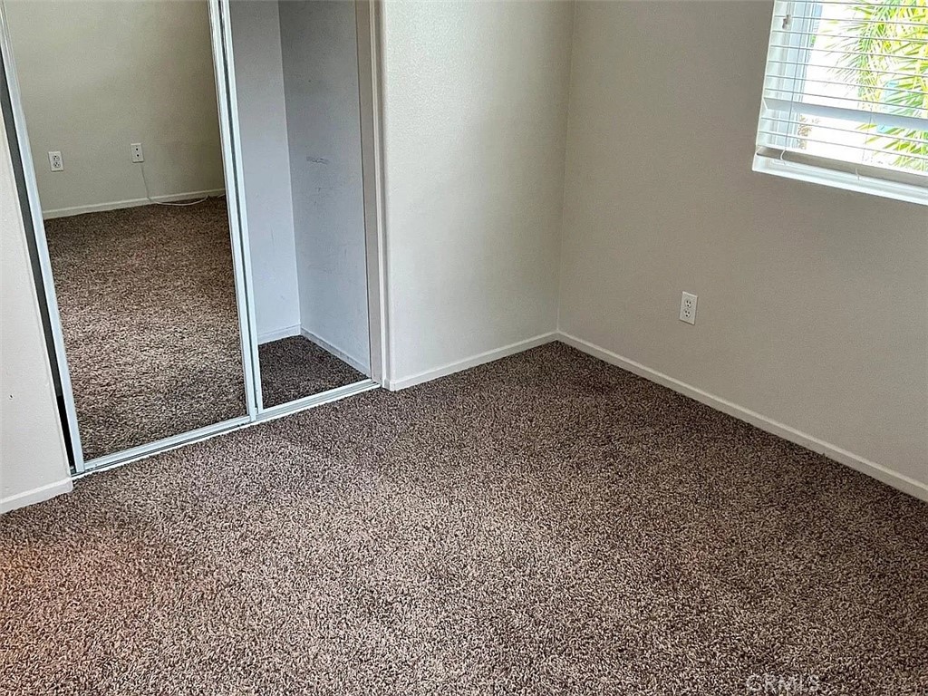 26456 Arboretum Way, Unit 1104 Murrieta, CA 92563 - Photo 8 of 12 an empty room with windows