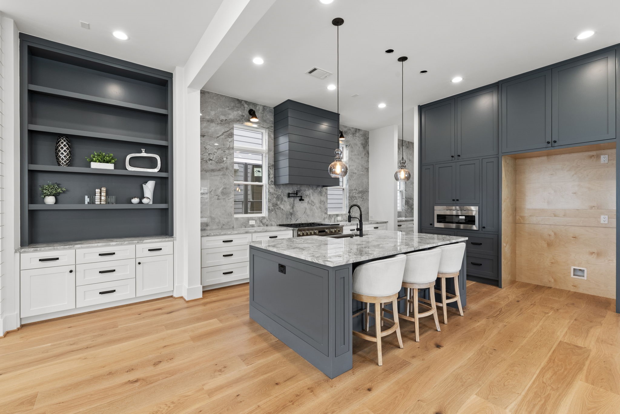 1315 Waverly Street Houston, TX 77008 - Photo 11 of 40 a large kitchen with stainless steel appliances kitchen island granite countertop a large stove a sink dishwasher and a dining table with wooden floor