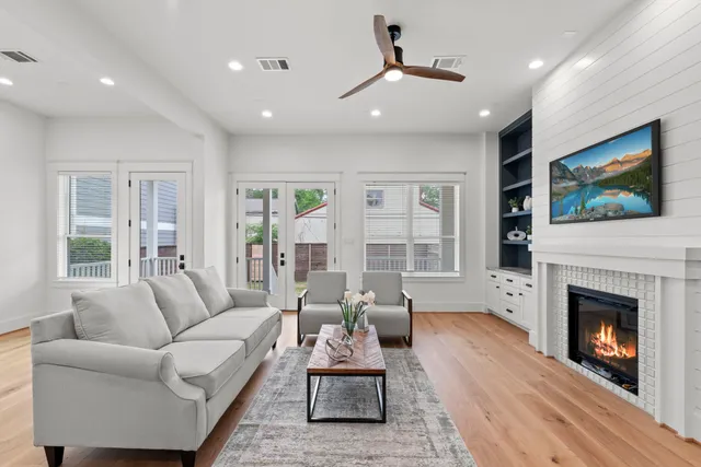 a living room with furniture a fireplace and a flat screen tv
