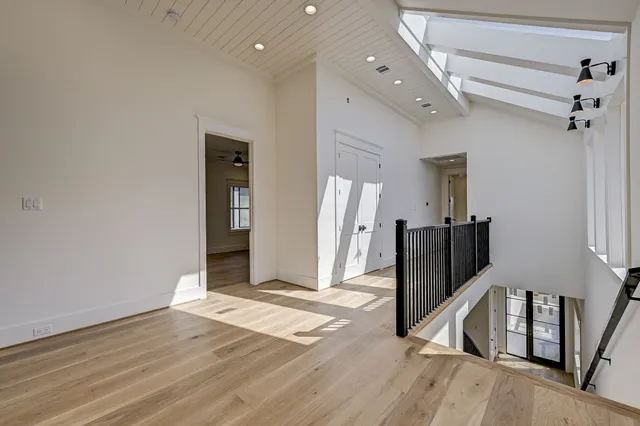 a view of a hallway with wooden floor and entryway