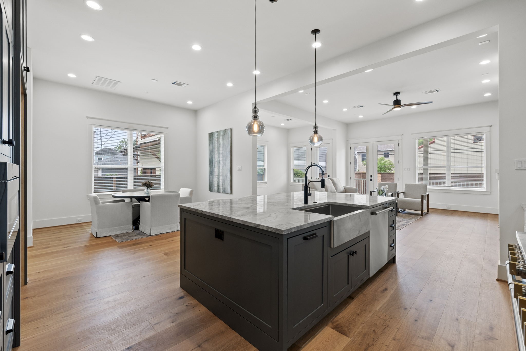 1315 Waverly Street Houston, TX 77008 - Photo 7 of 40 a kitchen with stainless steel appliances granite countertop wooden floors and sink
