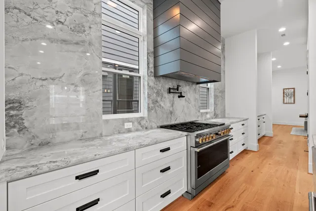 a kitchen with stainless steel appliances granite countertop a stove and a sink