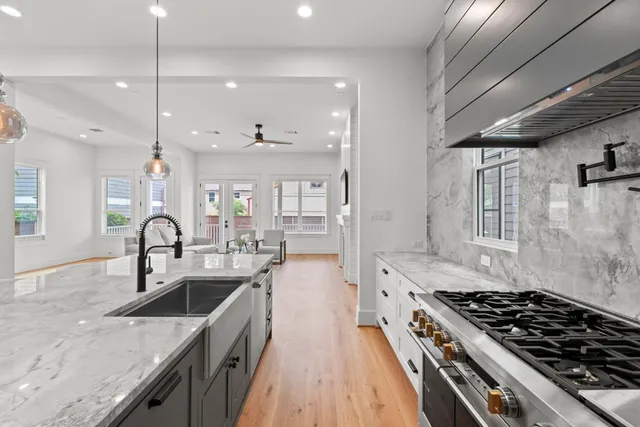 a kitchen with granite countertop a stove and a sink