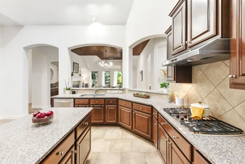 a kitchen with stainless steel appliances a refrigerator and a stove