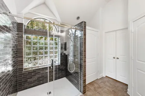 a spacious bathroom with double vanity and a mirror