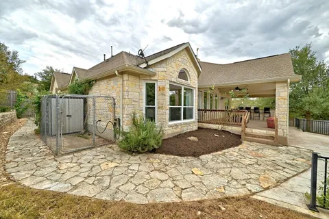 a view of a house with wooden fence