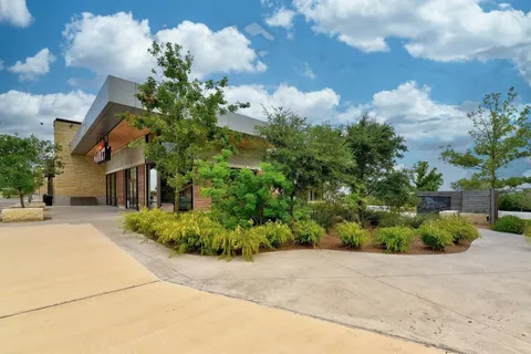 an aerial view of a house with a yard and trees