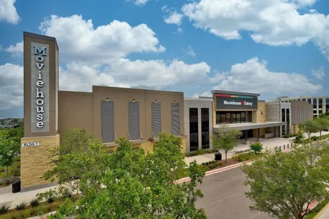 a view of a cars park in front of a building