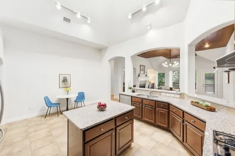 a kitchen with a sink stove and cabinets