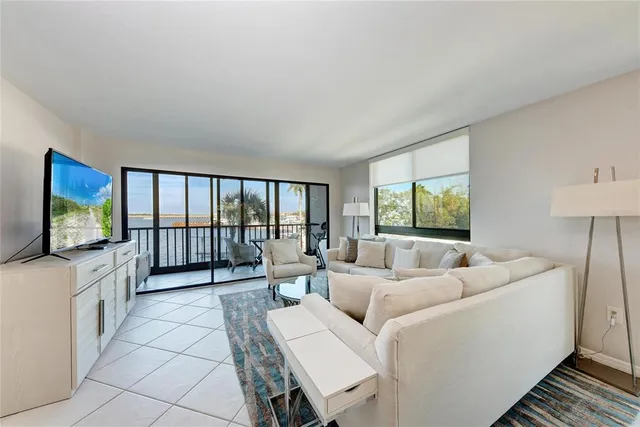 a large white kitchen with a table and chairs