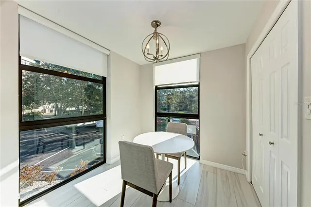 a kitchen with cabinets table and chairs