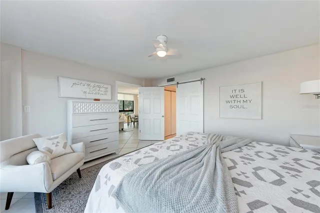 a bedroom with a bed and a lamp