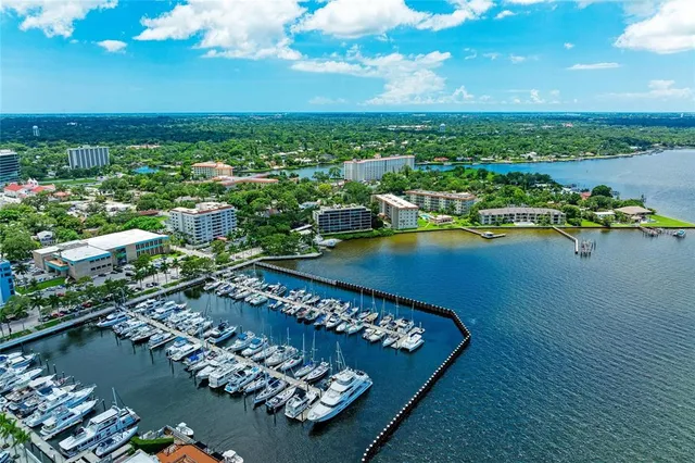 a aerial view of a house with a yard and lake view