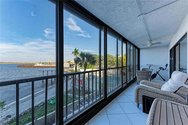 a view of swimming pool with outdoor seating and green space