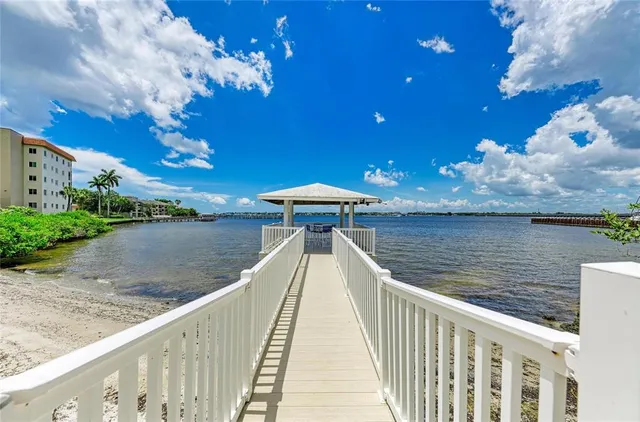 a living room with furniture and large windows