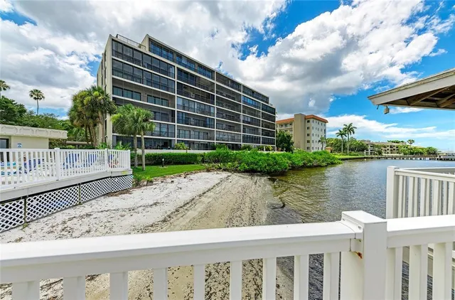 an aerial view of a house with a garden and lake view