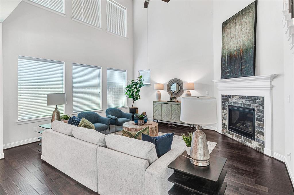 3613 Gloucester Road Richardson, TX 75082 - Photo 12 of 34 Main living area features tall ceilings, wall of windows to the yard and classy fireplace