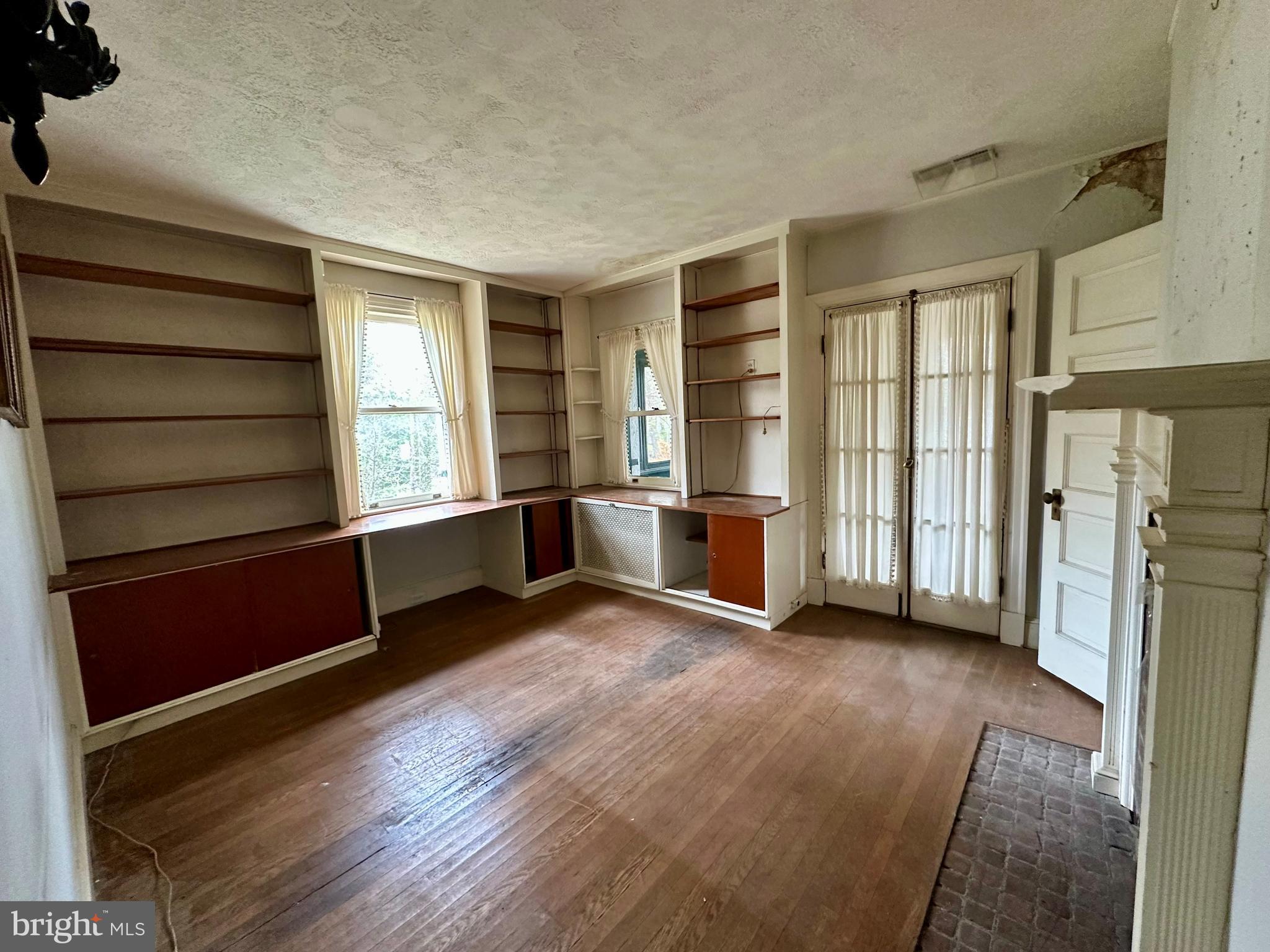 112 Elmhurst Road Baltimore, MD 21210 - Photo 19 of 29 a view of an empty room with a window and wooden floor
