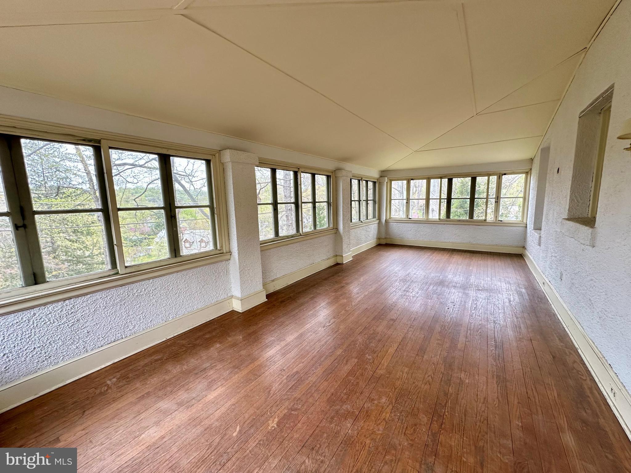 112 Elmhurst Road Baltimore, MD 21210 - Photo 9 of 29 wooden floor in an empty room with a window