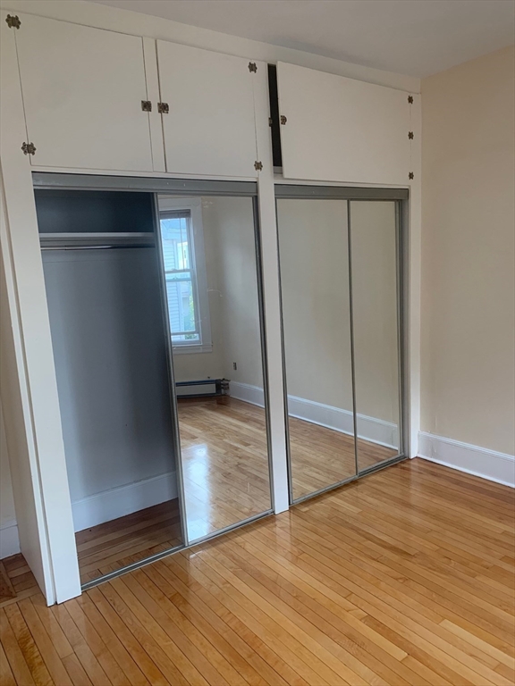 9 Kerwin Street, Unit 2 Boston, MA 02124 - Photo 6 of 13 a view of empty room with wooden floor