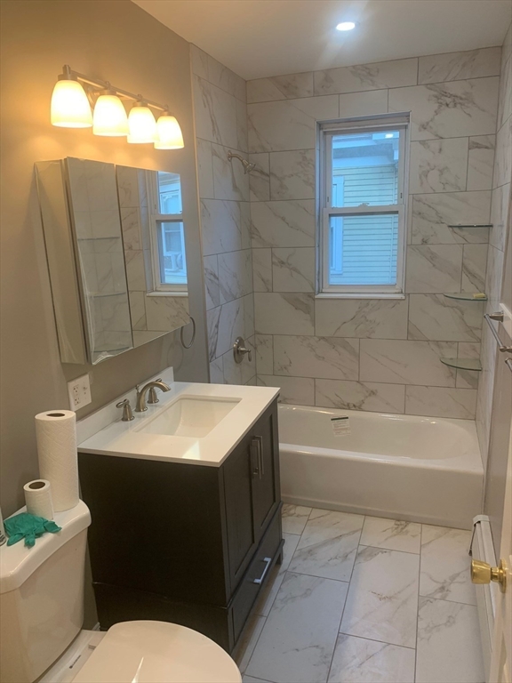 9 Kerwin Street, Unit 2 Boston, MA 02124 - Photo 9 of 13 a bathroom with a sink toilet vanity and bathtub