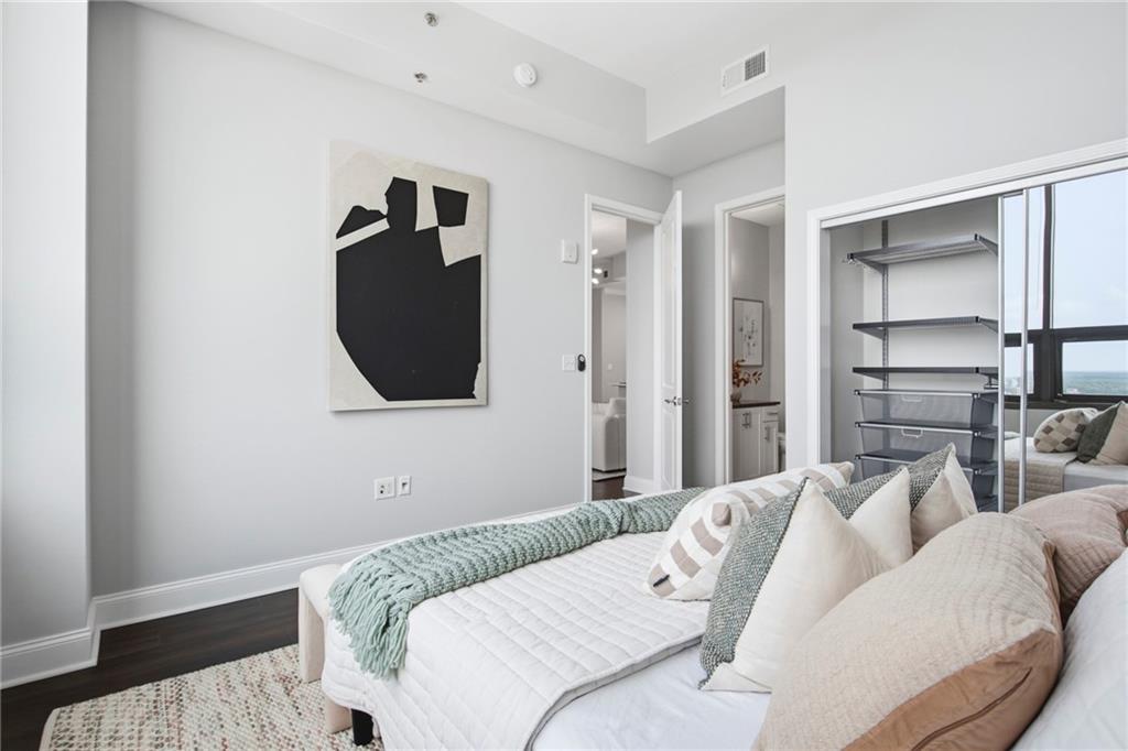 270 17th Street Northwest, Unit 4306 Atlanta, GA 30363 - Photo 18 of 37 a bedroom with a bed and a mirror