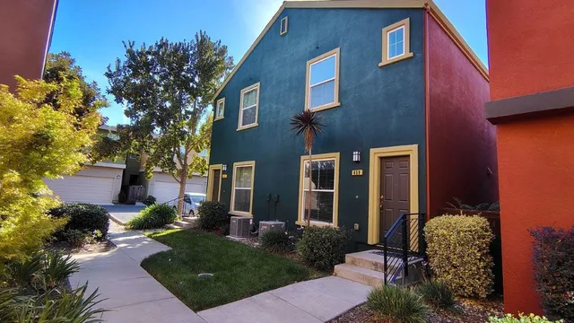 a view of a house with brick walls and flower plants