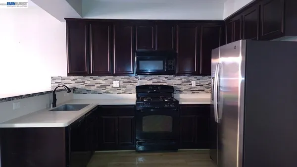 a kitchen with a sink stove and refrigerator
