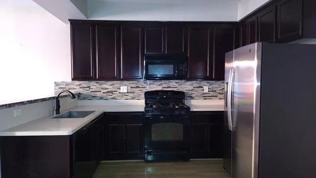 a kitchen with a sink stove and refrigerator