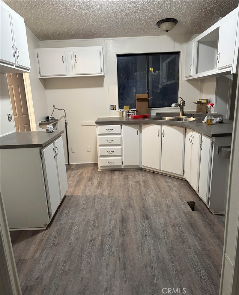2720 Lebec Oaks Road Lebec, CA 93243 - Photo 1 of 4 a kitchen with cabinets wooden floor and a stove