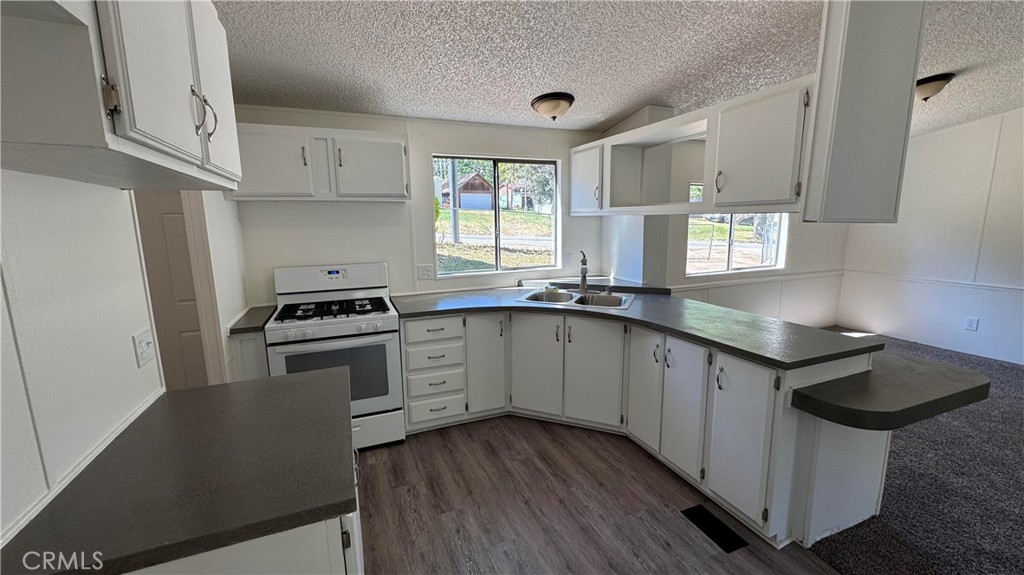 2720 Lebec Oaks Road Lebec, CA 93243 - Photo 12 of 24 a kitchen with granite countertop a sink a counter space appliances and cabinets