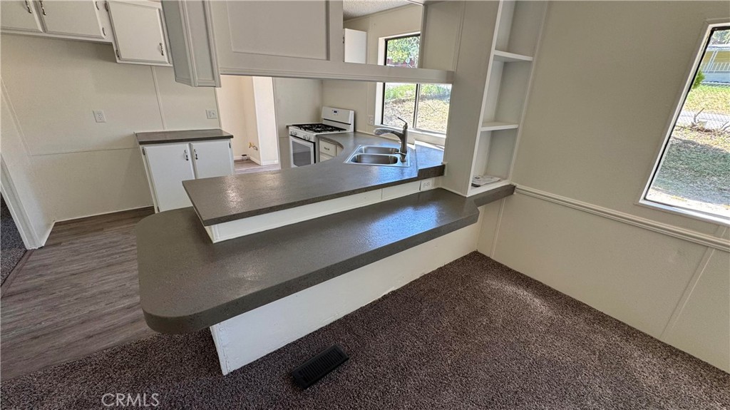 2720 Lebec Oaks Road Lebec, CA 93243 - Photo 15 of 24 a kitchen with kitchen island a counter space a sink and a window