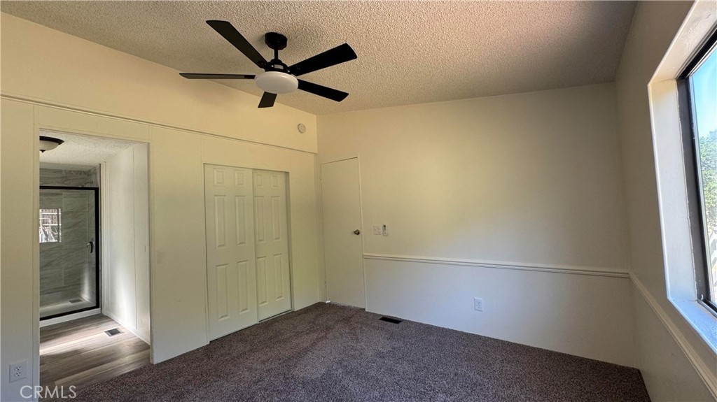 2720 Lebec Oaks Road Lebec, CA 93243 - Photo 19 of 24 an empty room with closet and ceiling fan
