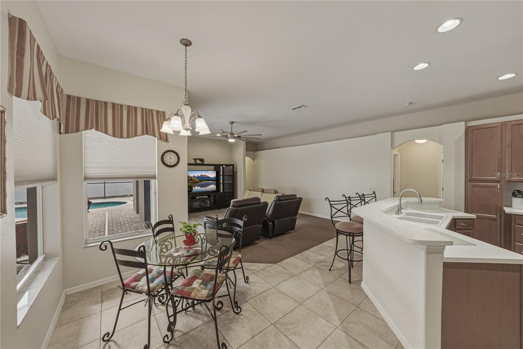 1542 Swamp Rose Lane Trinity, FL 34655 - Photo 23 of 64 a view of a dining room with furniture window and wooden floor