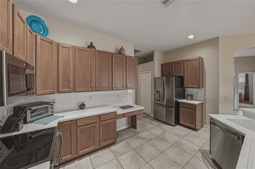 1542 Swamp Rose Lane Trinity, FL 34655 - Photo 29 of 64 a kitchen with a sink cabinets and stainless steel appliances