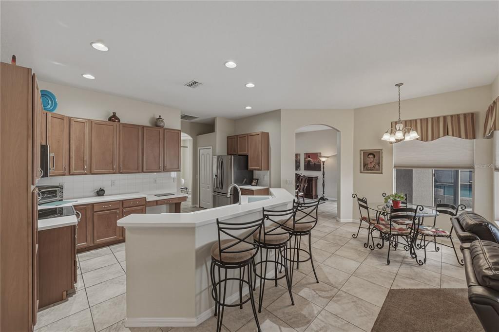 1542 Swamp Rose Lane Trinity, FL 34655 - Photo 30 of 64 a large kitchen with a table and chairs