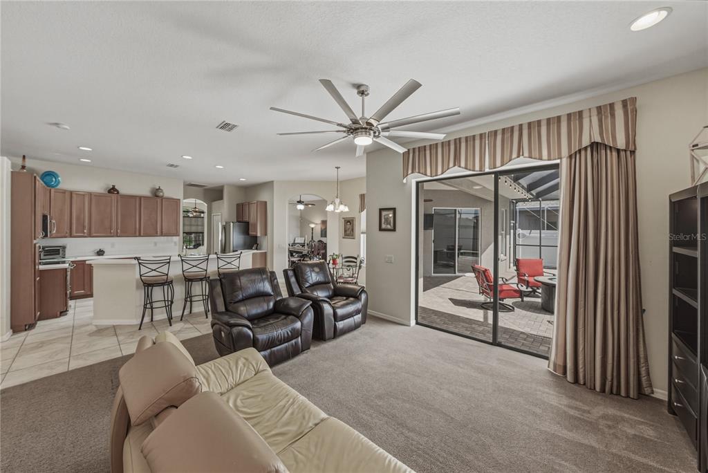 1542 Swamp Rose Lane Trinity, FL 34655 - Photo 31 of 64 a living room with furniture a ceiling fan and a window