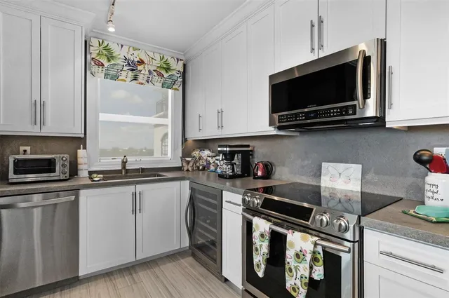 a kitchen with stainless steel appliances granite countertop a stove and a microwave