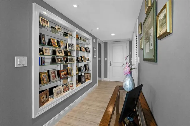a view of a hallway with wooden floor and closet