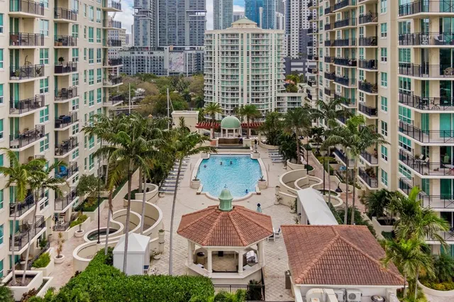 an aerial view of a house with an outdoor space and seating area
