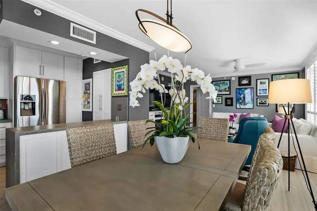 a living room with furniture flowerpot and a chandelier
